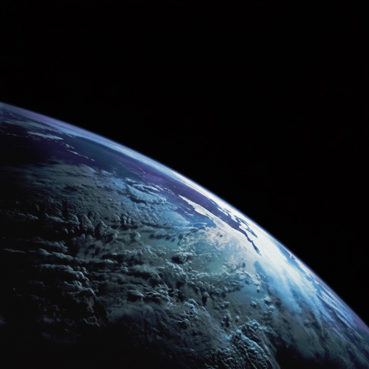 Close-up view of the Earth's curvature from space, showing a blue and white planet edge against the blackness of space.